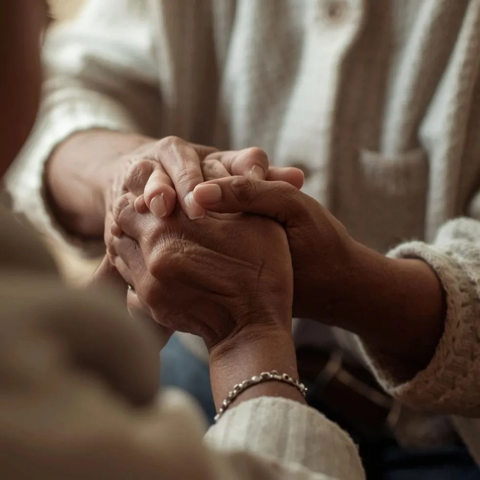 A caregiver sharing a warm moment with an elderly client